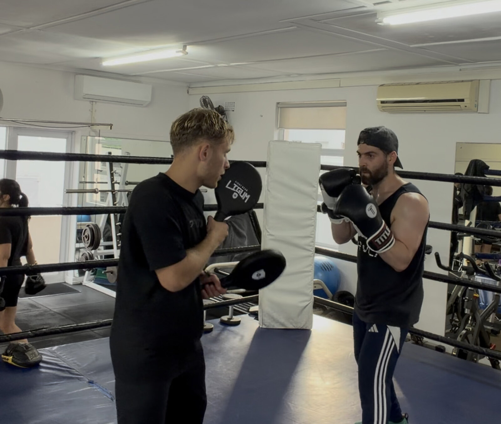 Doron coaching a client on the pads in the ring at Top Floor Boxing, Sea Point.